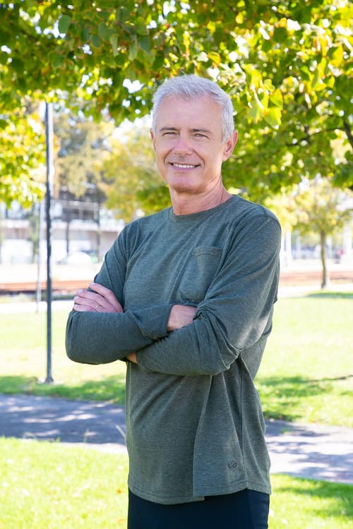 positive mature man with crossed arms standing outside smiling vertical shot mature sporty person active lifestyle concept 3